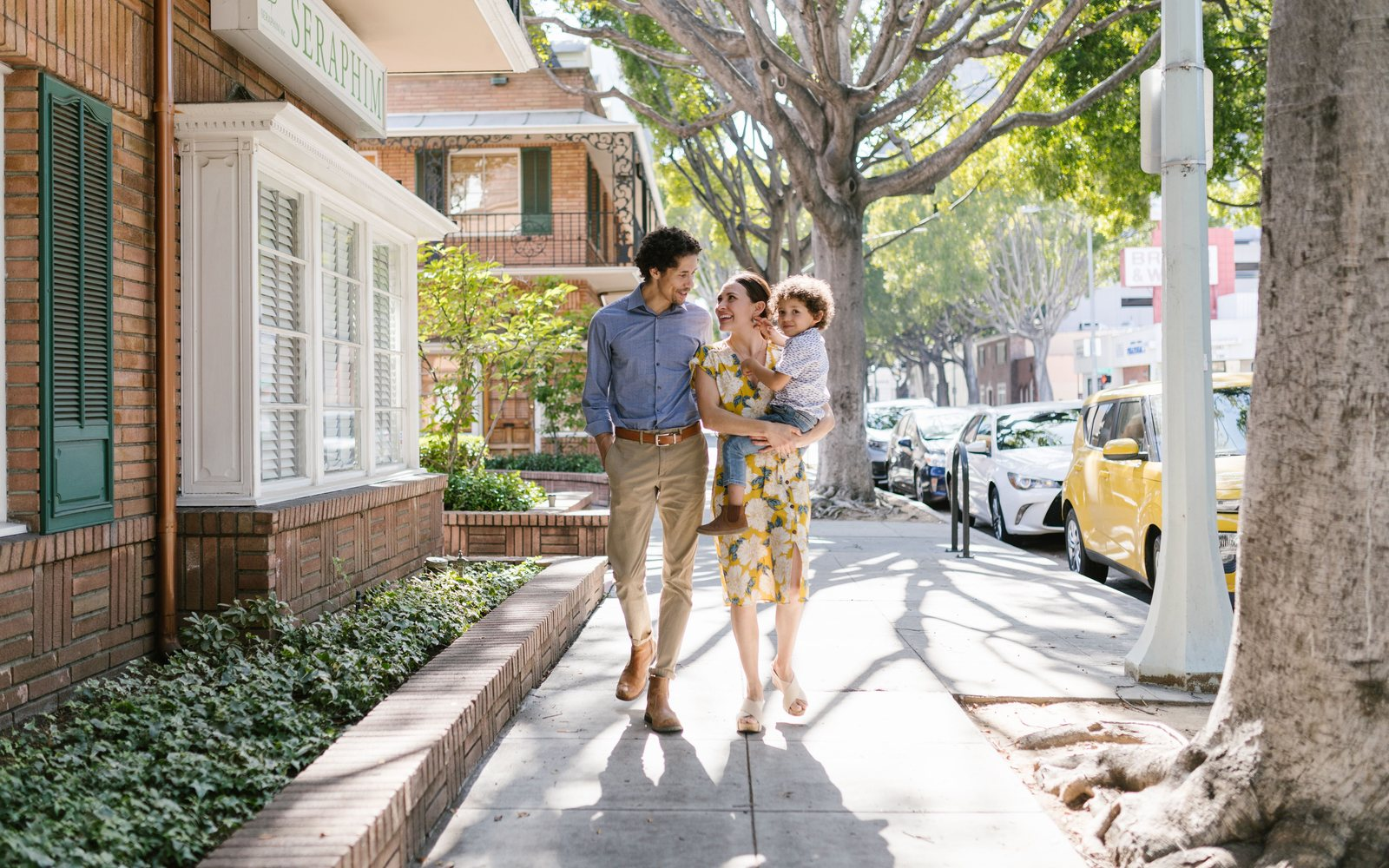 Family walking together on a neighborhood sidewalk